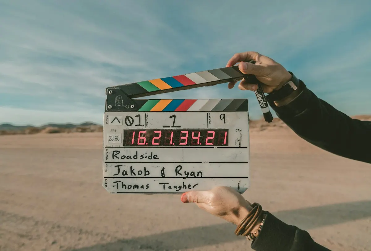A clapperboard held up on a beach location shoot